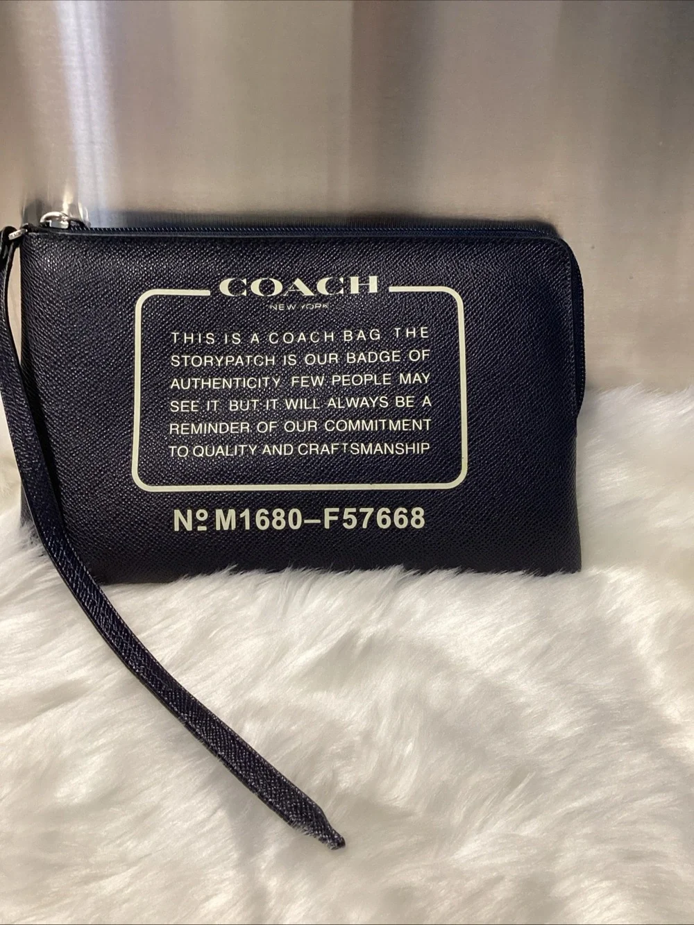 Coach Navy Wristlet with Cream Logo Text